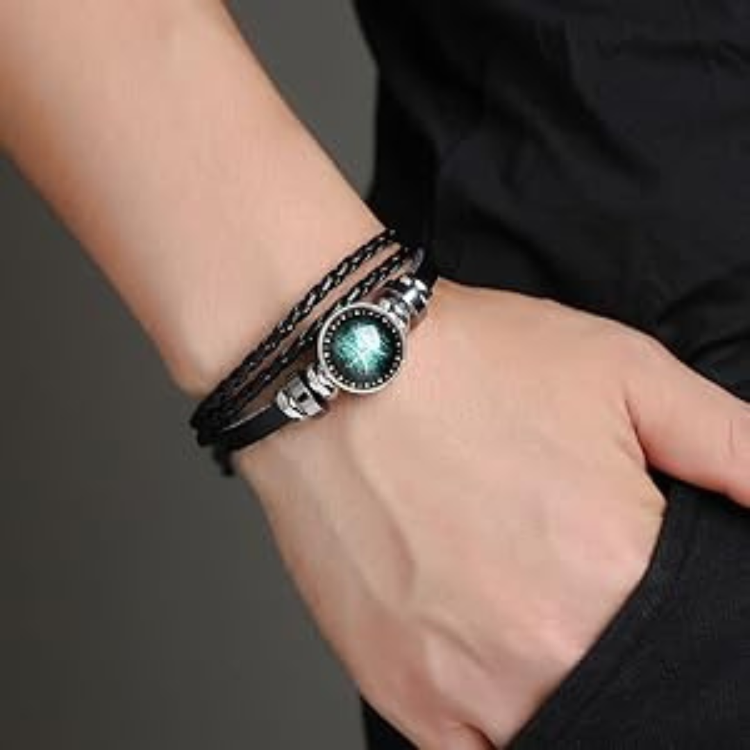 Black braided leather bracelet with a circle pendant that has an astrological symbol being worn by a male model