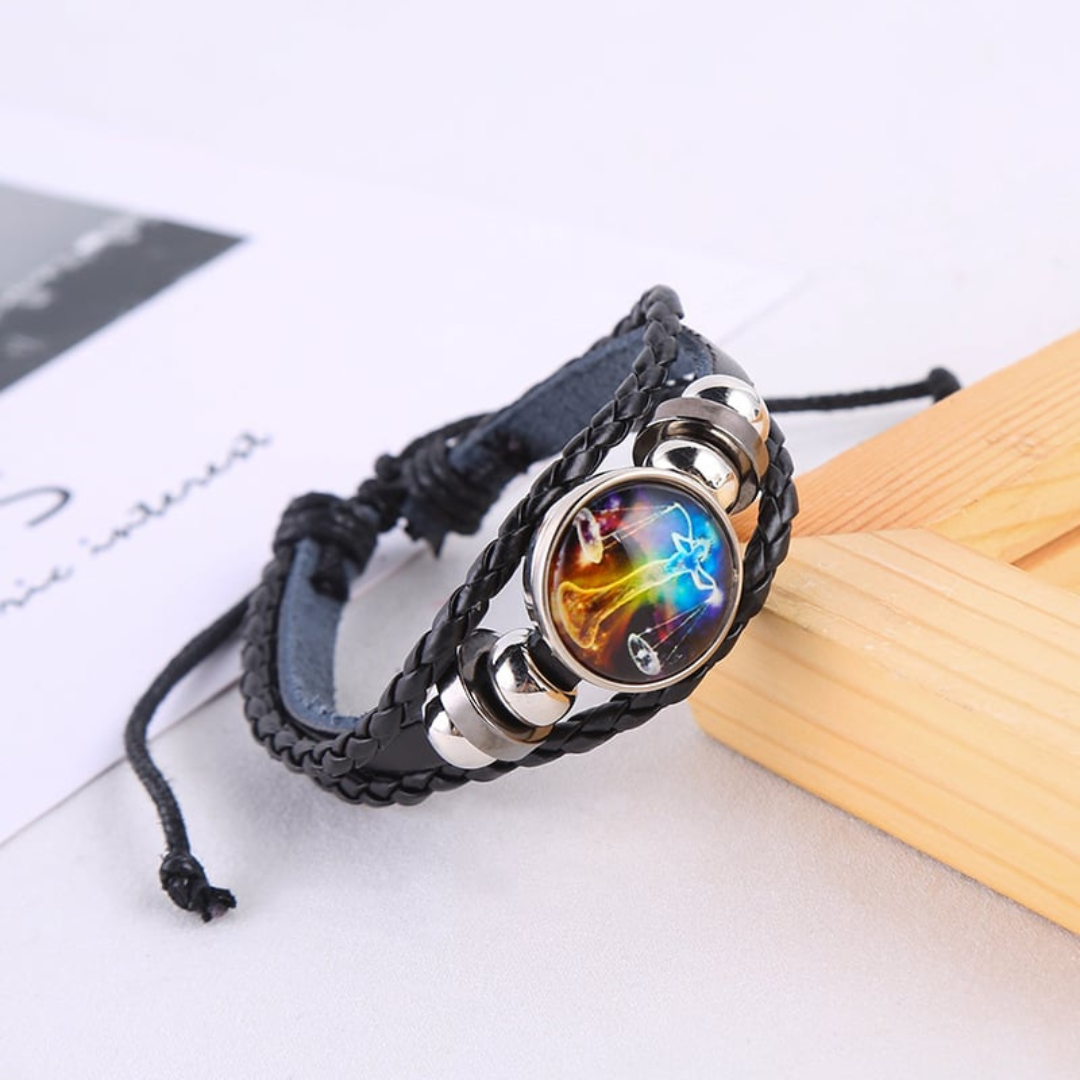 Black braided leather bracelet with a circle pendant that has a Libra astrological symbol