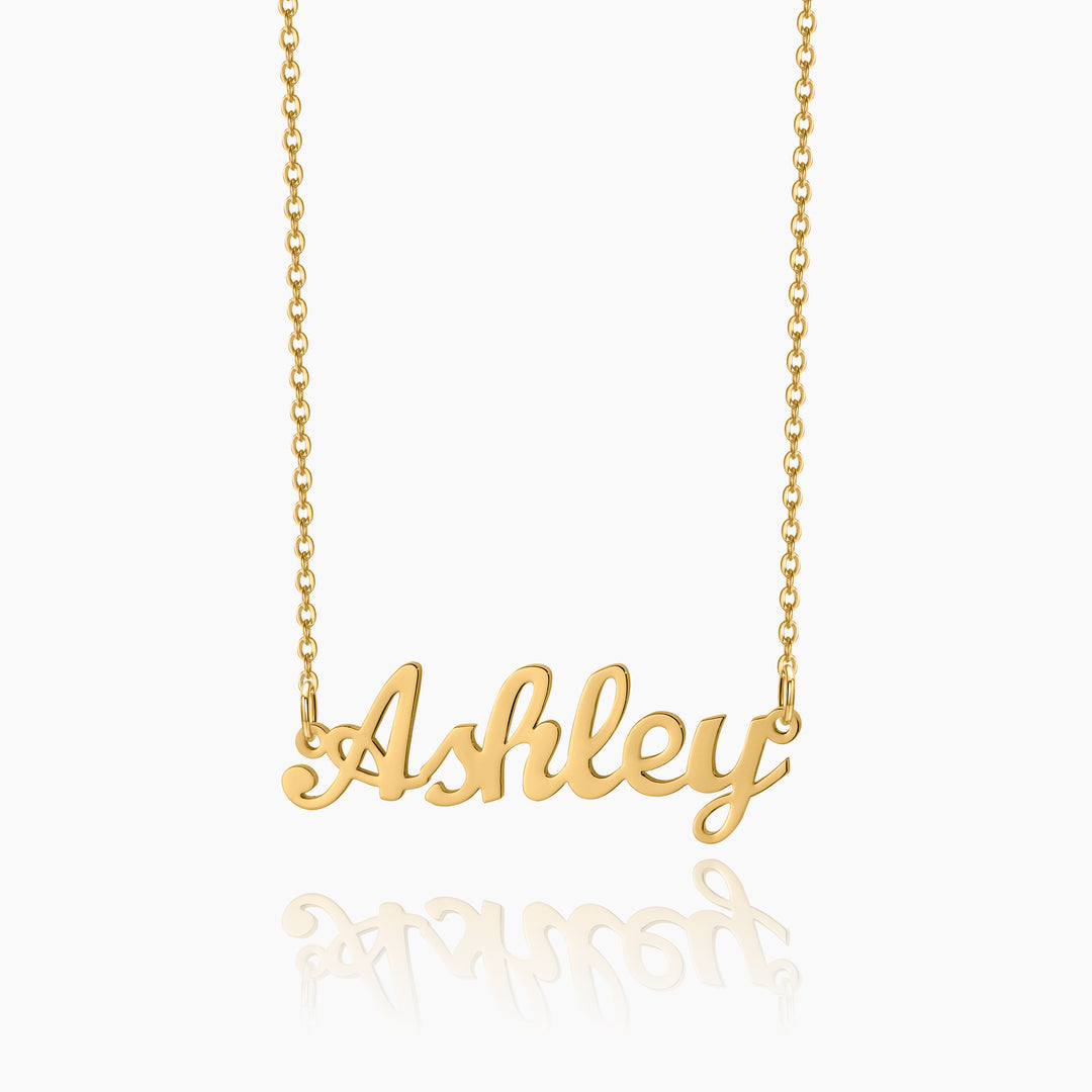 A gold chain necklace with a customized name pendant with a white background