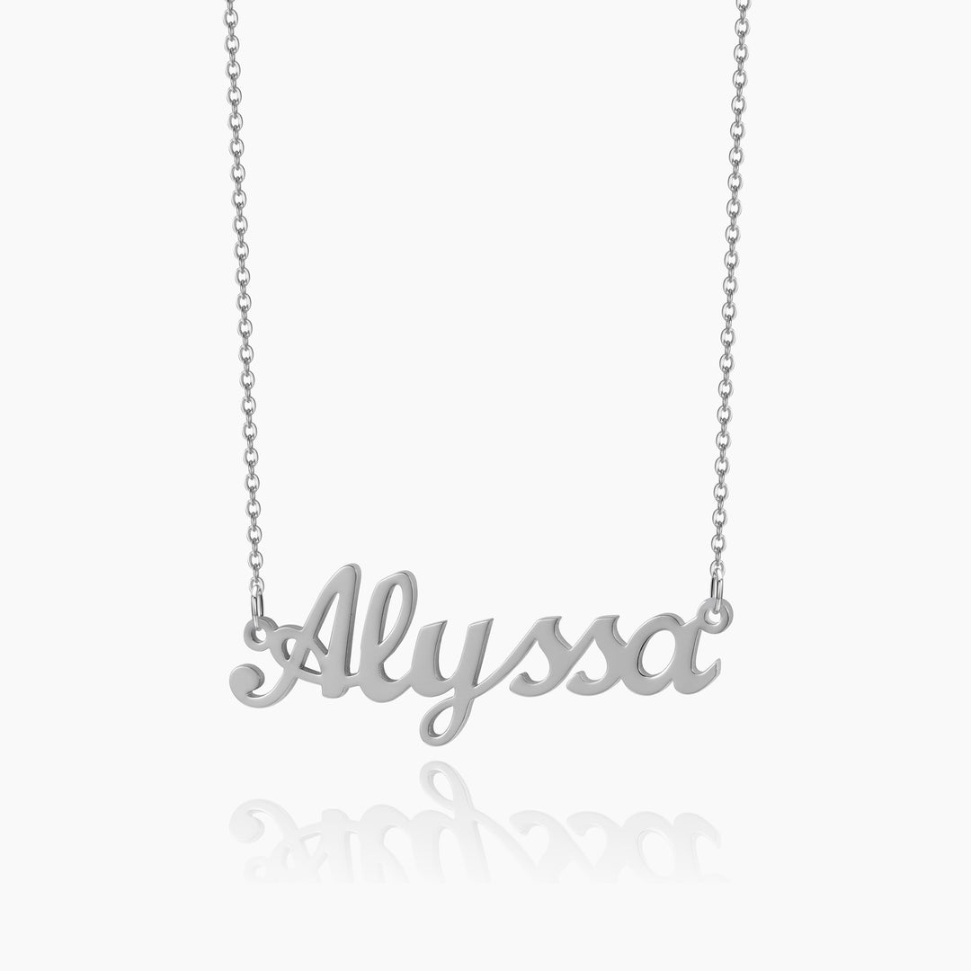 A silver chain necklace with a customized name pendant with a white background