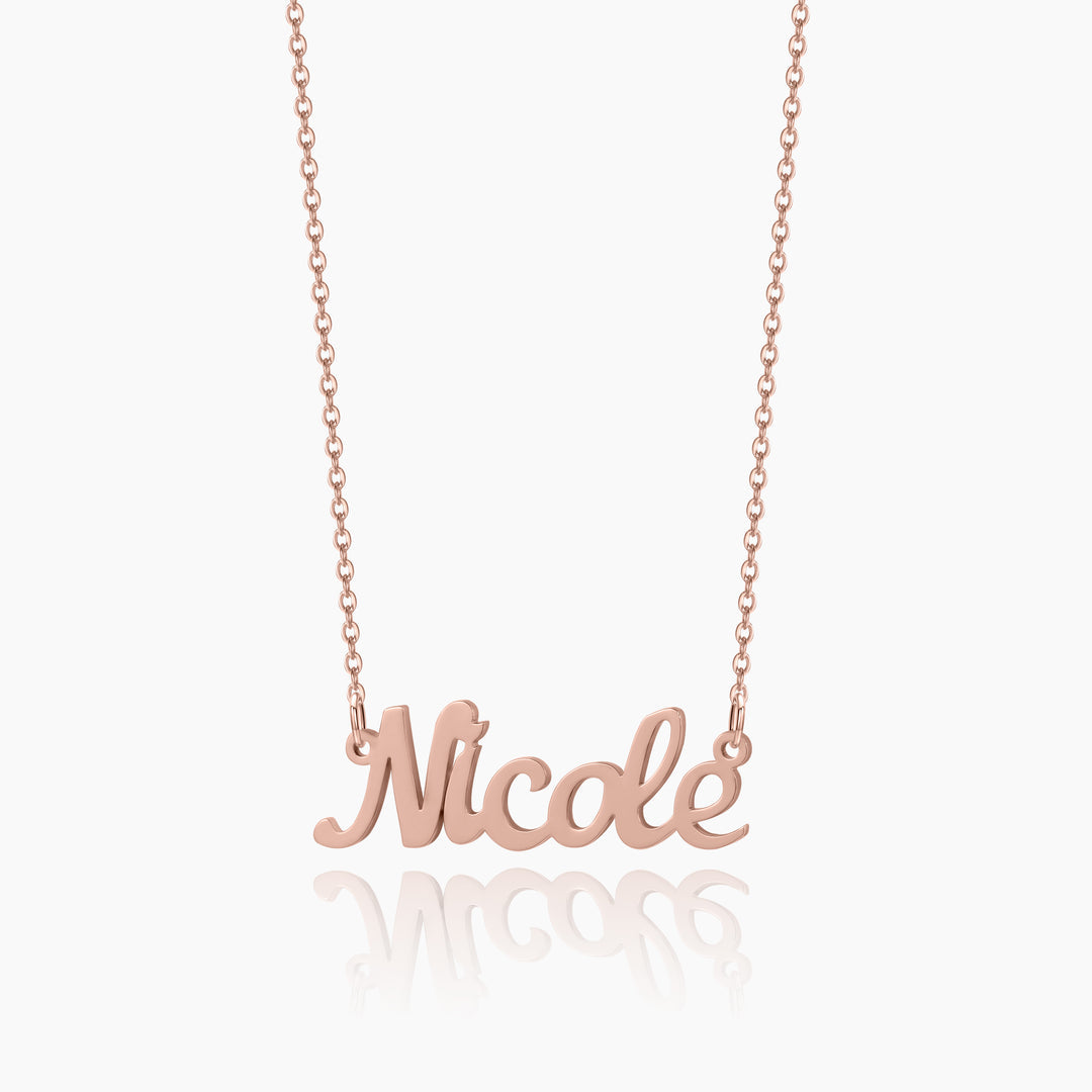 A rosegold chain necklace with a customized name pendant with a white background