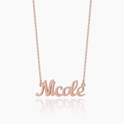 A rosegold chain necklace with a customized name pendant with a white background